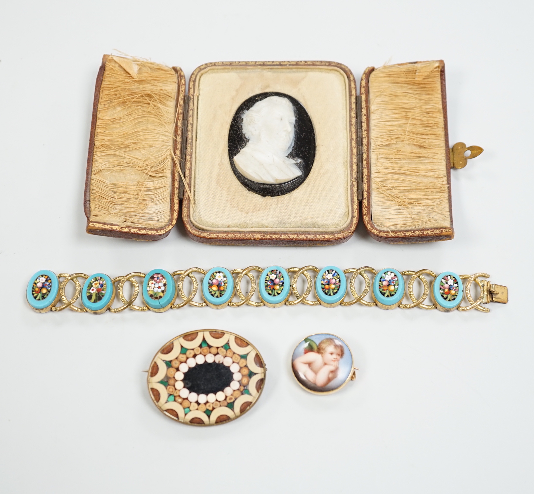 A Tassie style cased cameo, a micro-mosaic bracelet, a pietra dura brooch and a porcelain brooch.